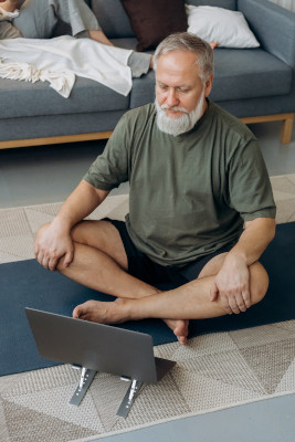 Image of man taking an online yoga class
