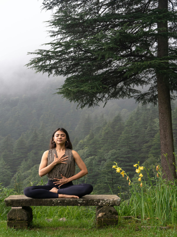 Woman doing yoga in the forest